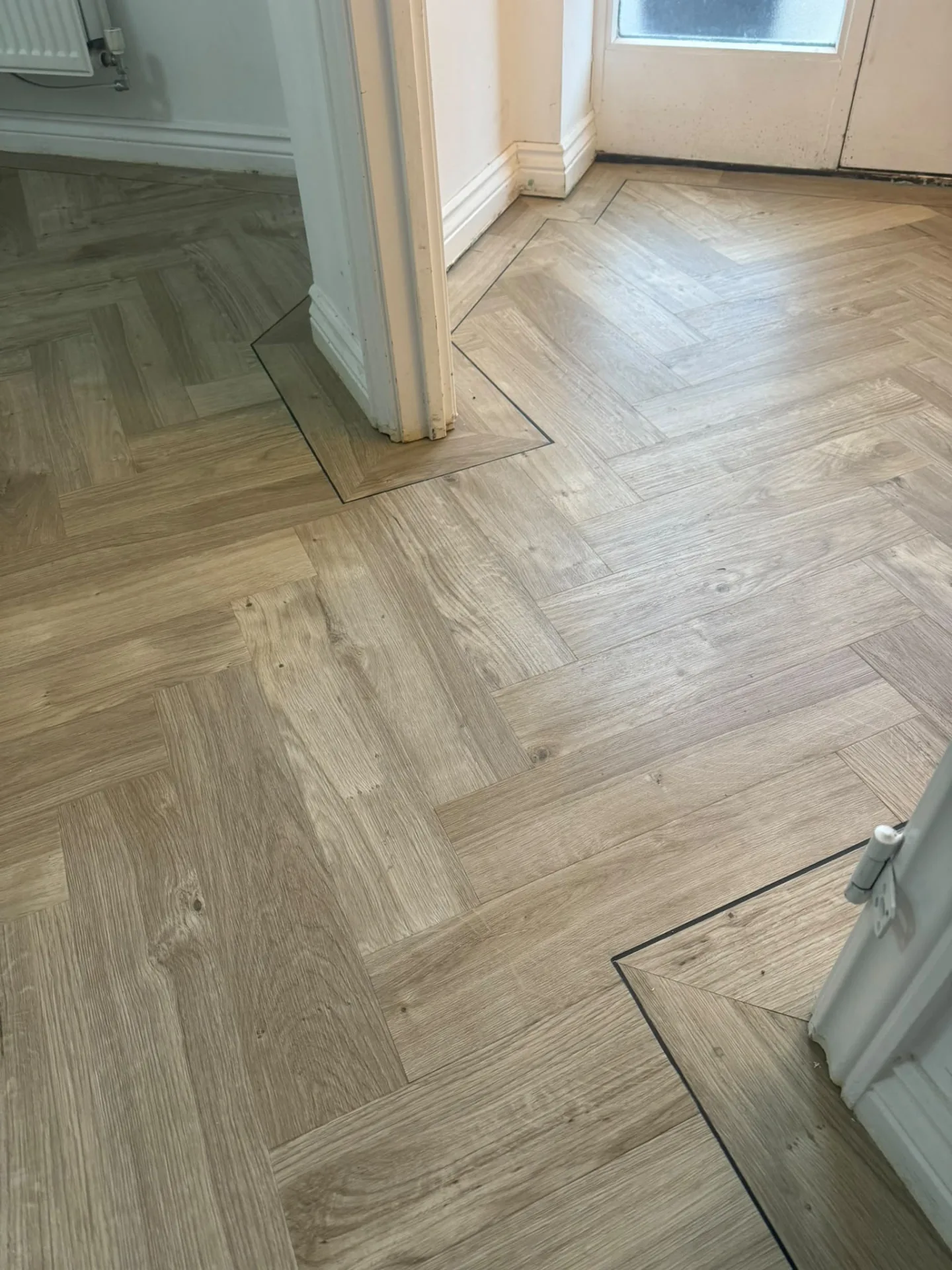 Herringbone LVT with border detail cut around door frames, Signature Carpets and Flooring, Greater Manchester