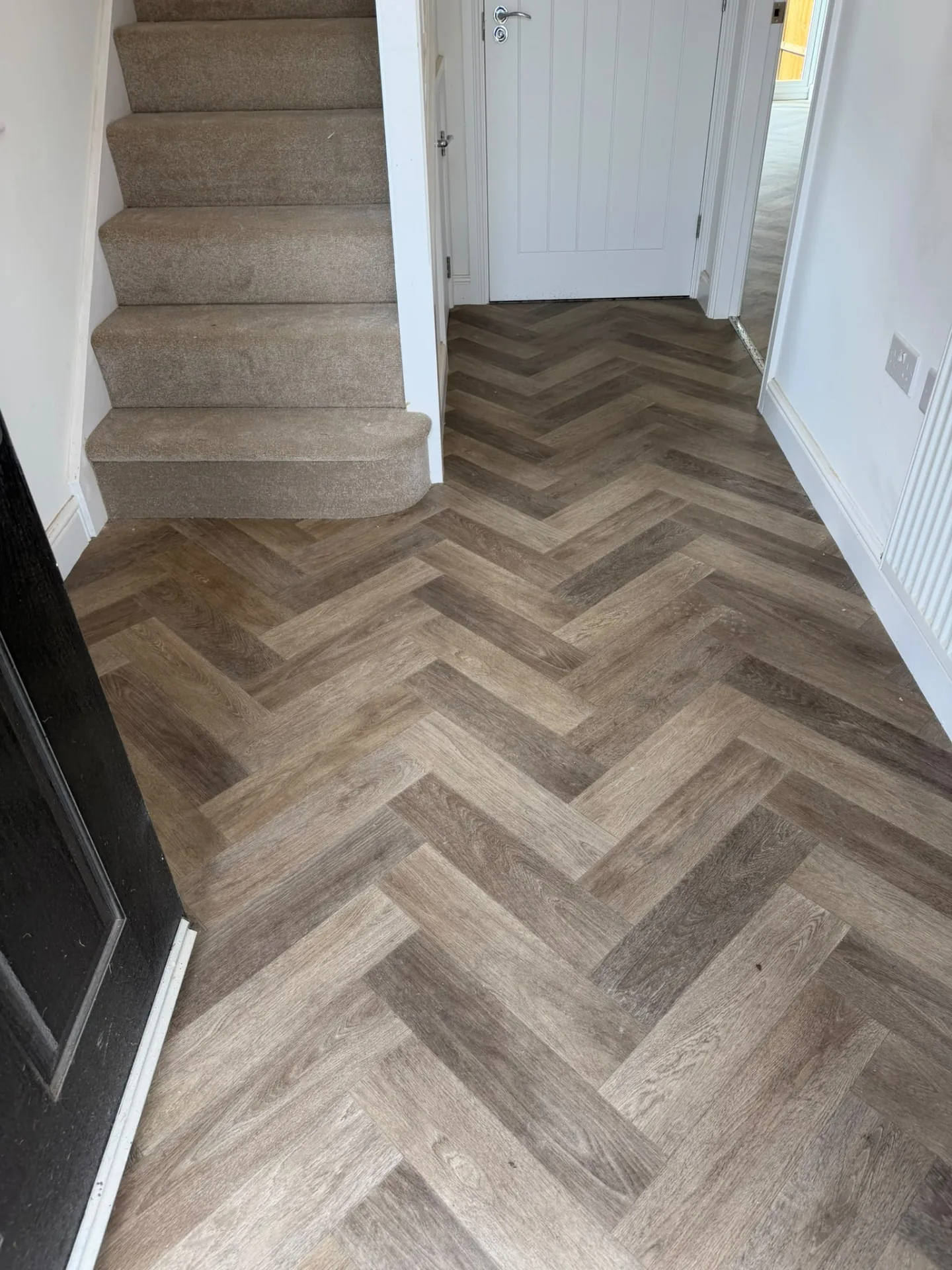 Herringbone vinyl flooring fitted in a hallway at the foot of the stairs, Signature Carpets and Flooring, Greater Manchester