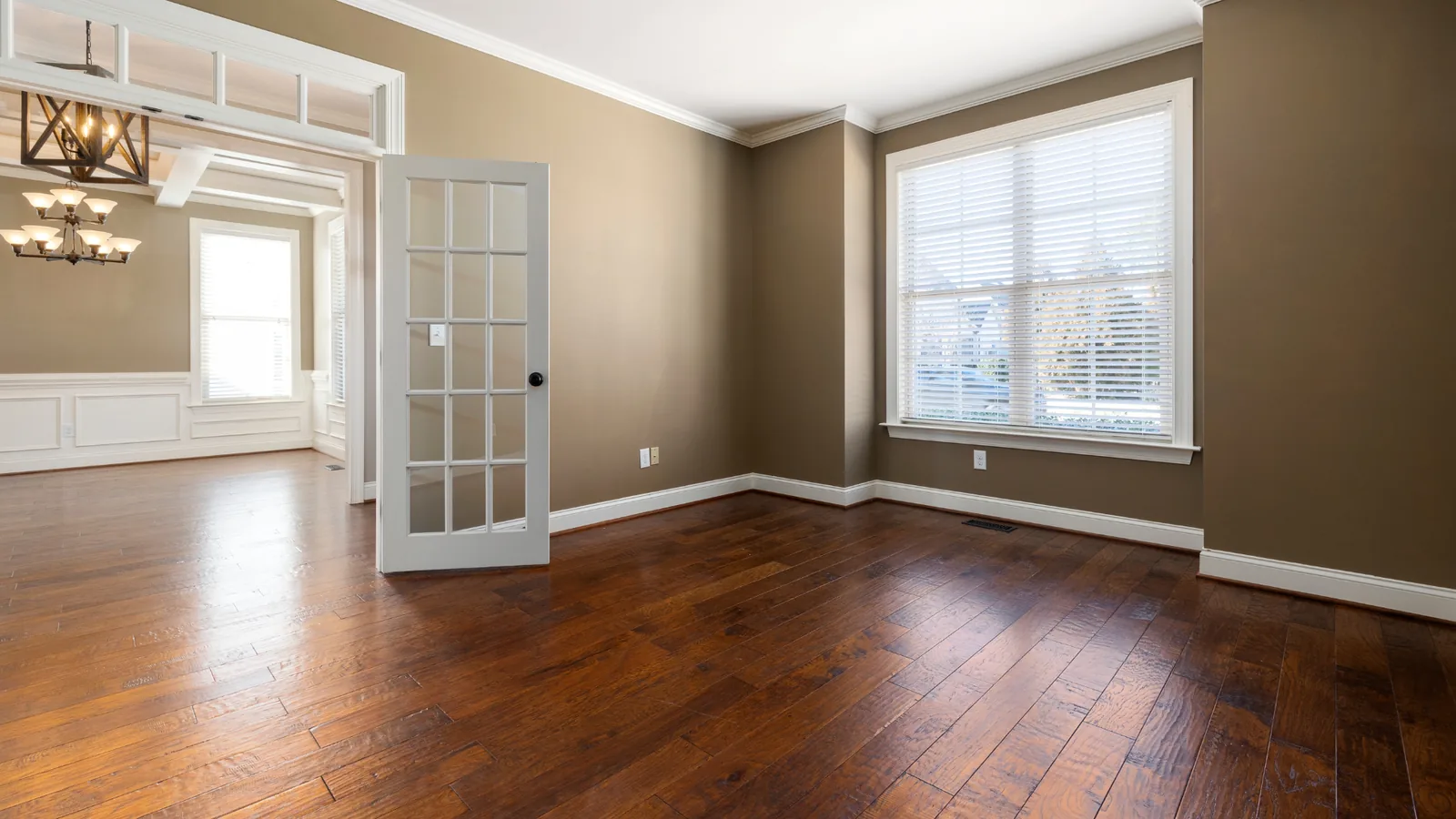Hard-wearing wood-effect flooring in an empty rental property, Signature Carpets and Flooring