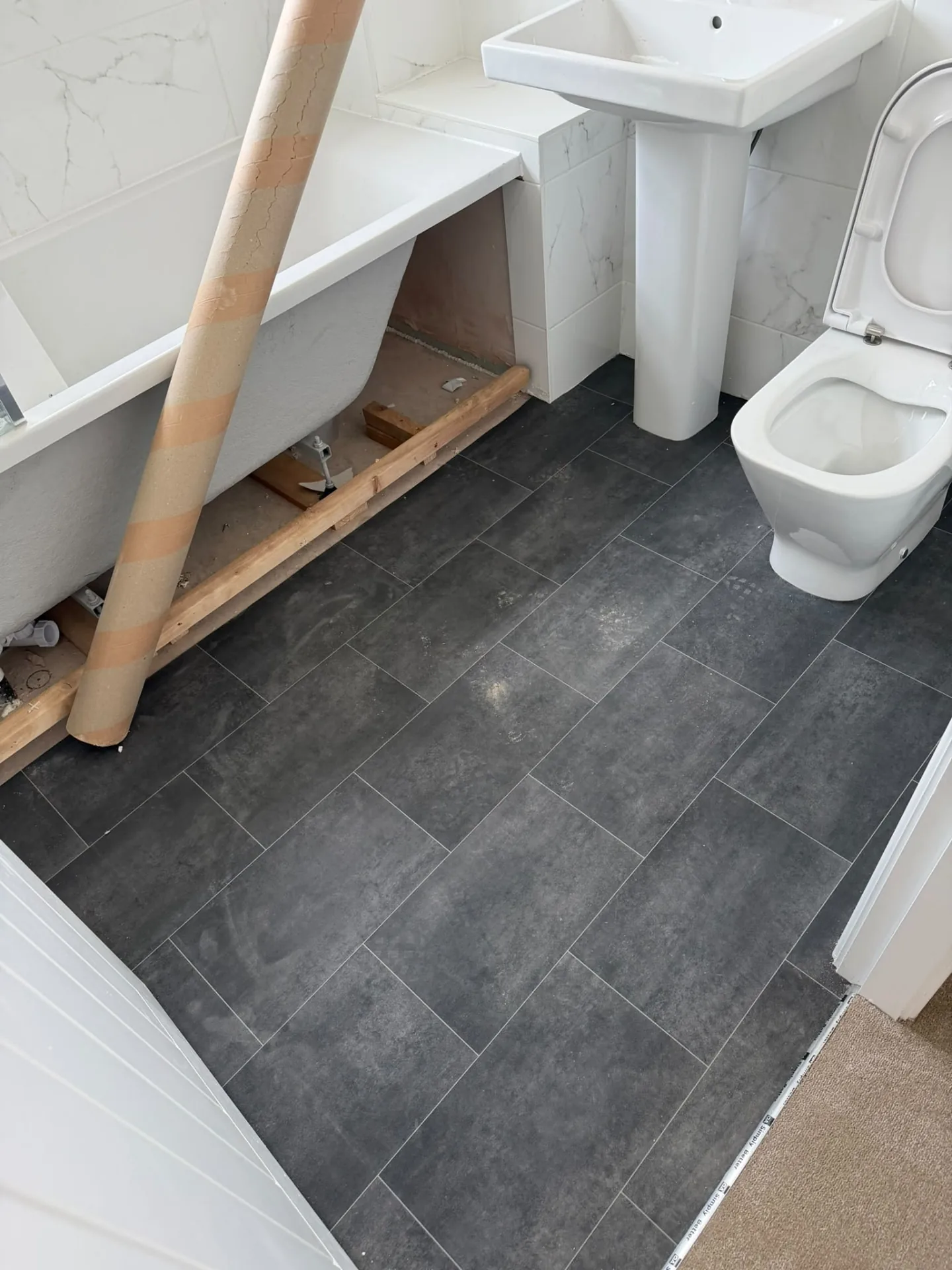 Dark stone-effect tile vinyl fitted in a bathroom, Signature Carpets and Flooring, Greater Manchester