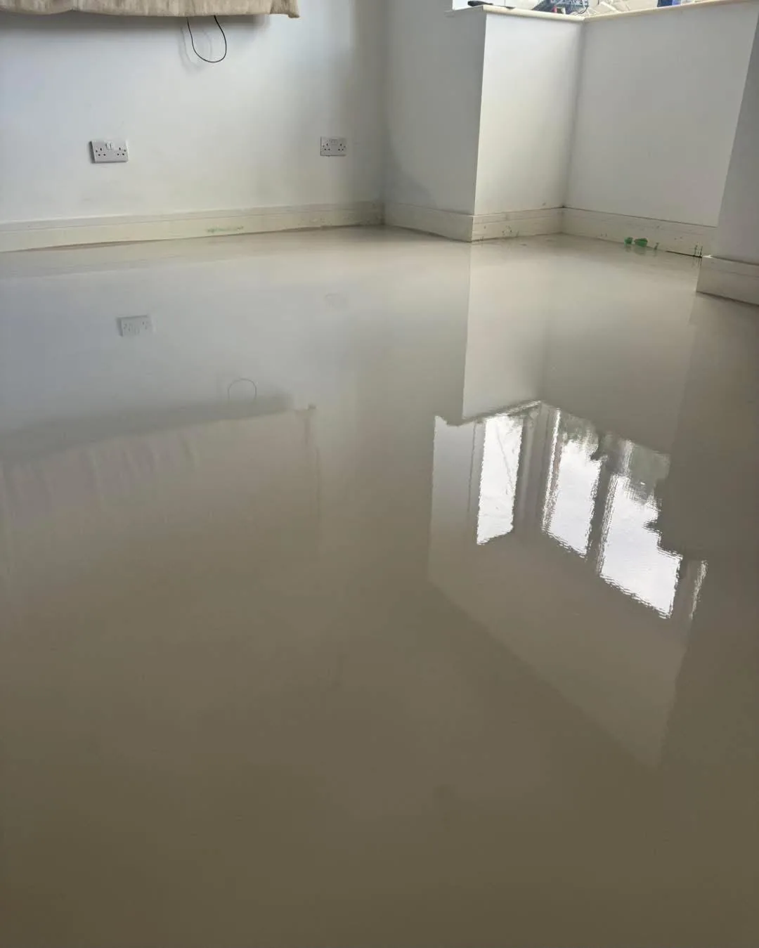 Self-levelling screed poured to prepare a subfloor for new flooring, Signature Carpets and Flooring, Greater Manchester