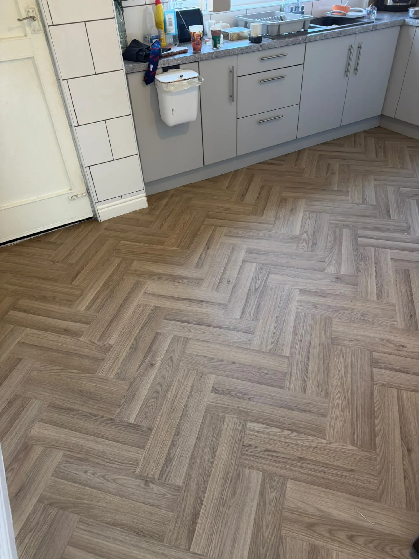Herringbone vinyl kitchen floor fitted up to the units, Signature Carpets and Flooring, Greater Manchester