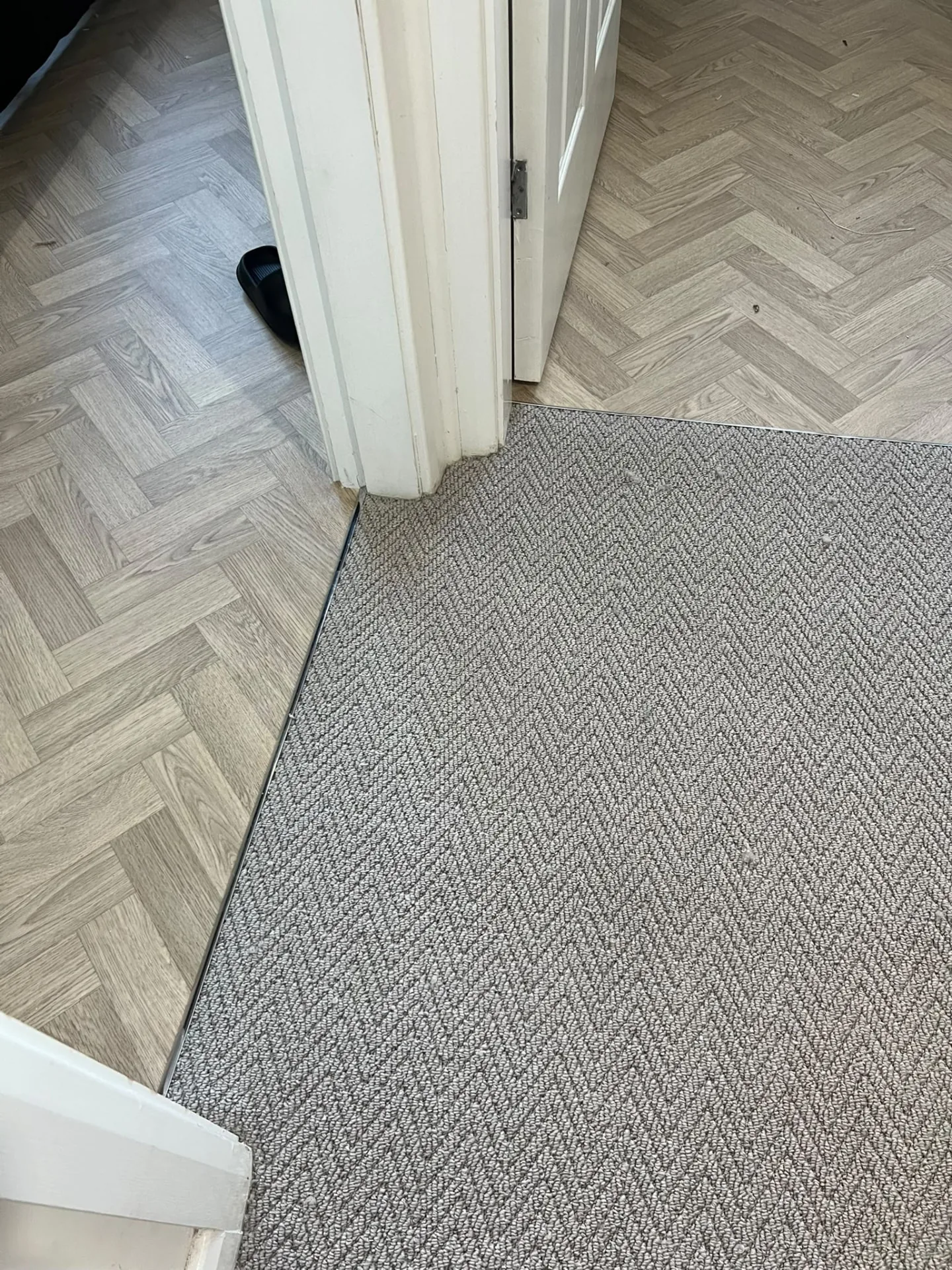 Carpet neatly joined to patterned vinyl at a doorway threshold, Signature Carpets and Flooring, Greater Manchester