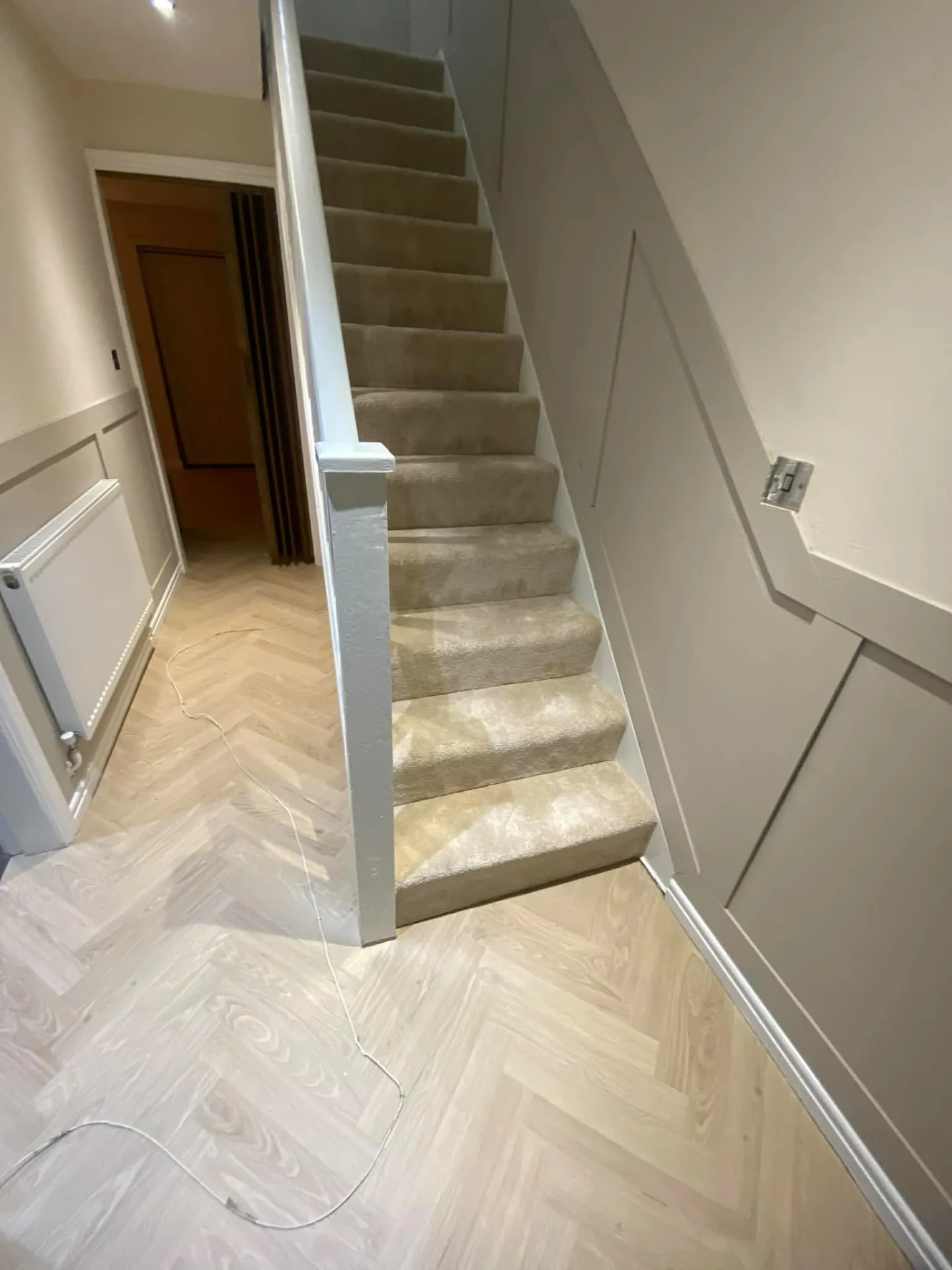 Beige carpeted staircase meeting patterned hall flooring, Signature Carpets and Flooring, Greater Manchester