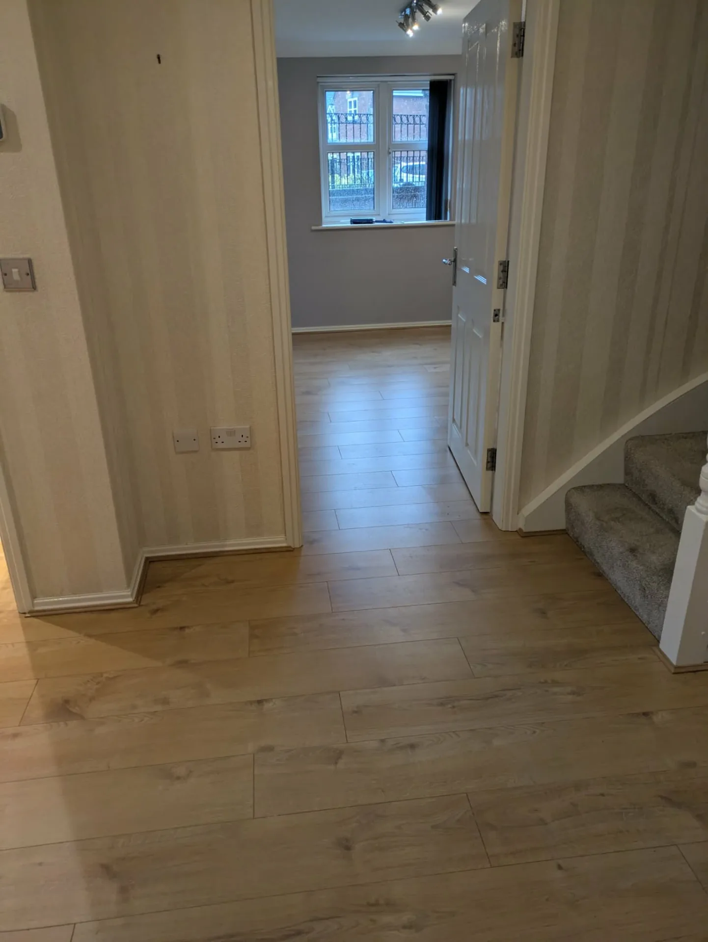 Laminate flooring running from the hallway into the front room, Signature Carpets and Flooring, Greater Manchester