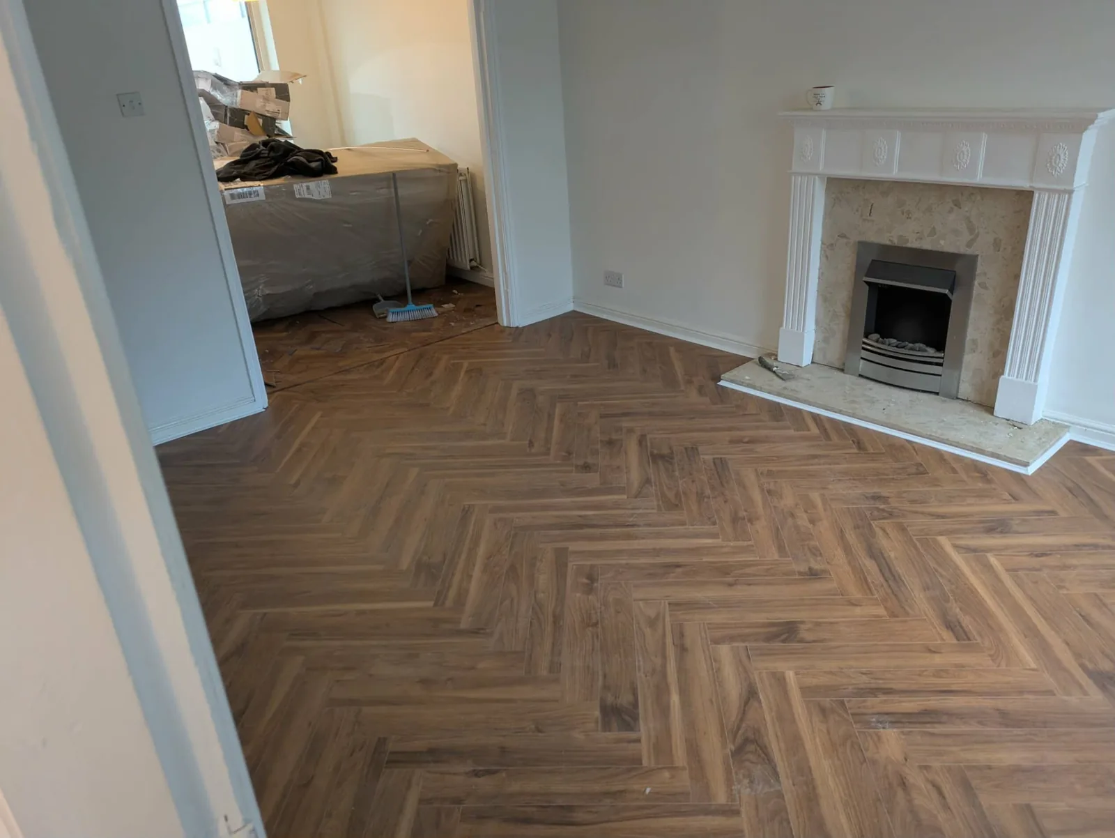 Walnut herringbone LVT flooring fitted in a living room, Signature Carpets and Flooring, Greater Manchester