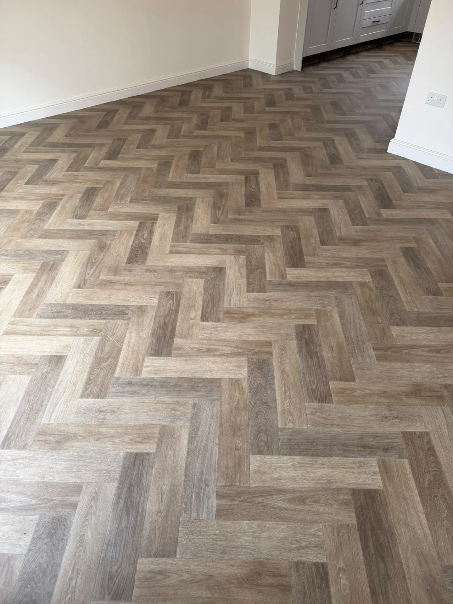 Herringbone wood-effect vinyl flooring fitted in a dining room, Signature Carpets and Flooring, Greater Manchester
