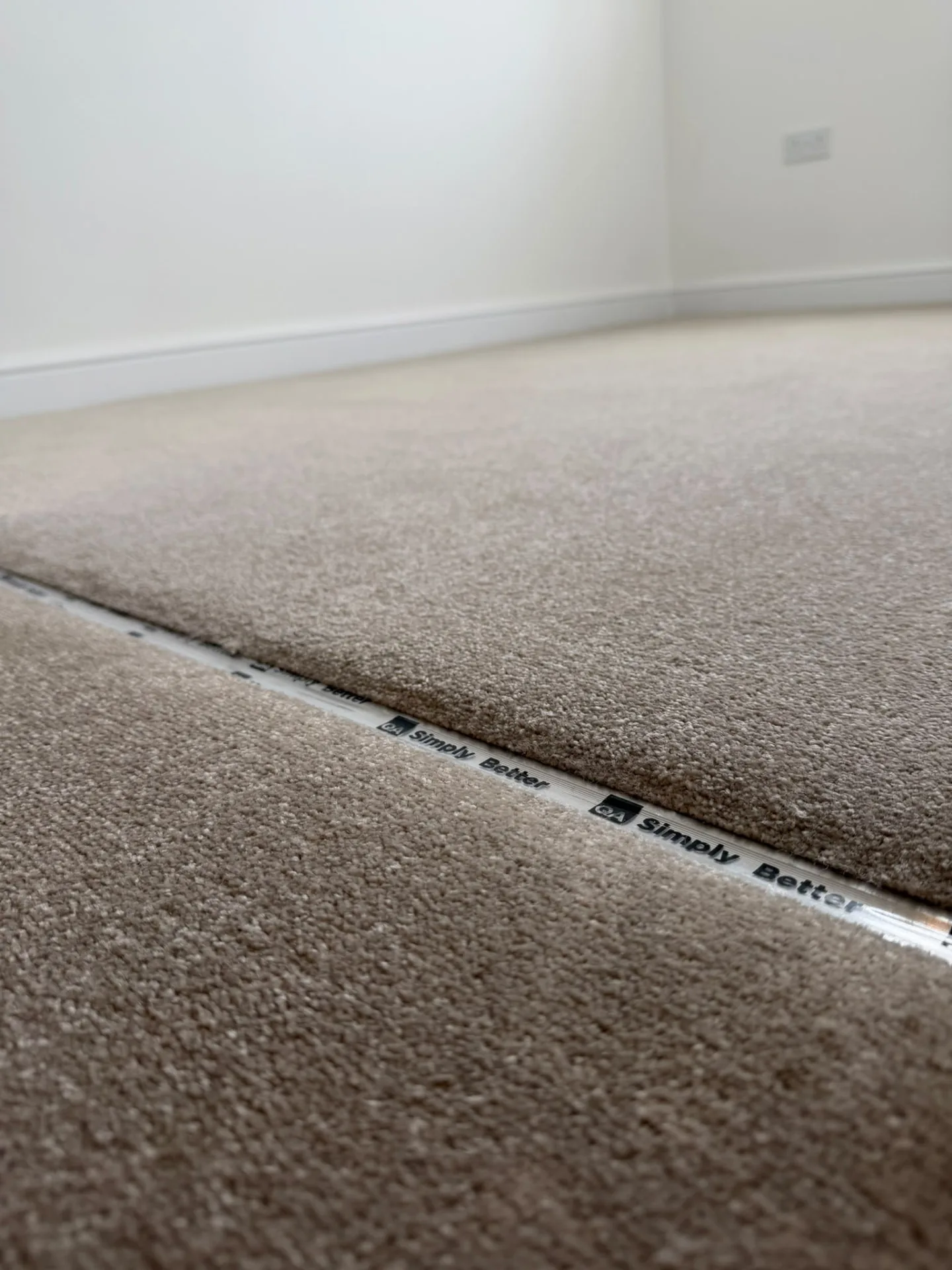 Close-up of carpet finished with a metal door bar at a threshold, Signature Carpets and Flooring, Greater Manchester