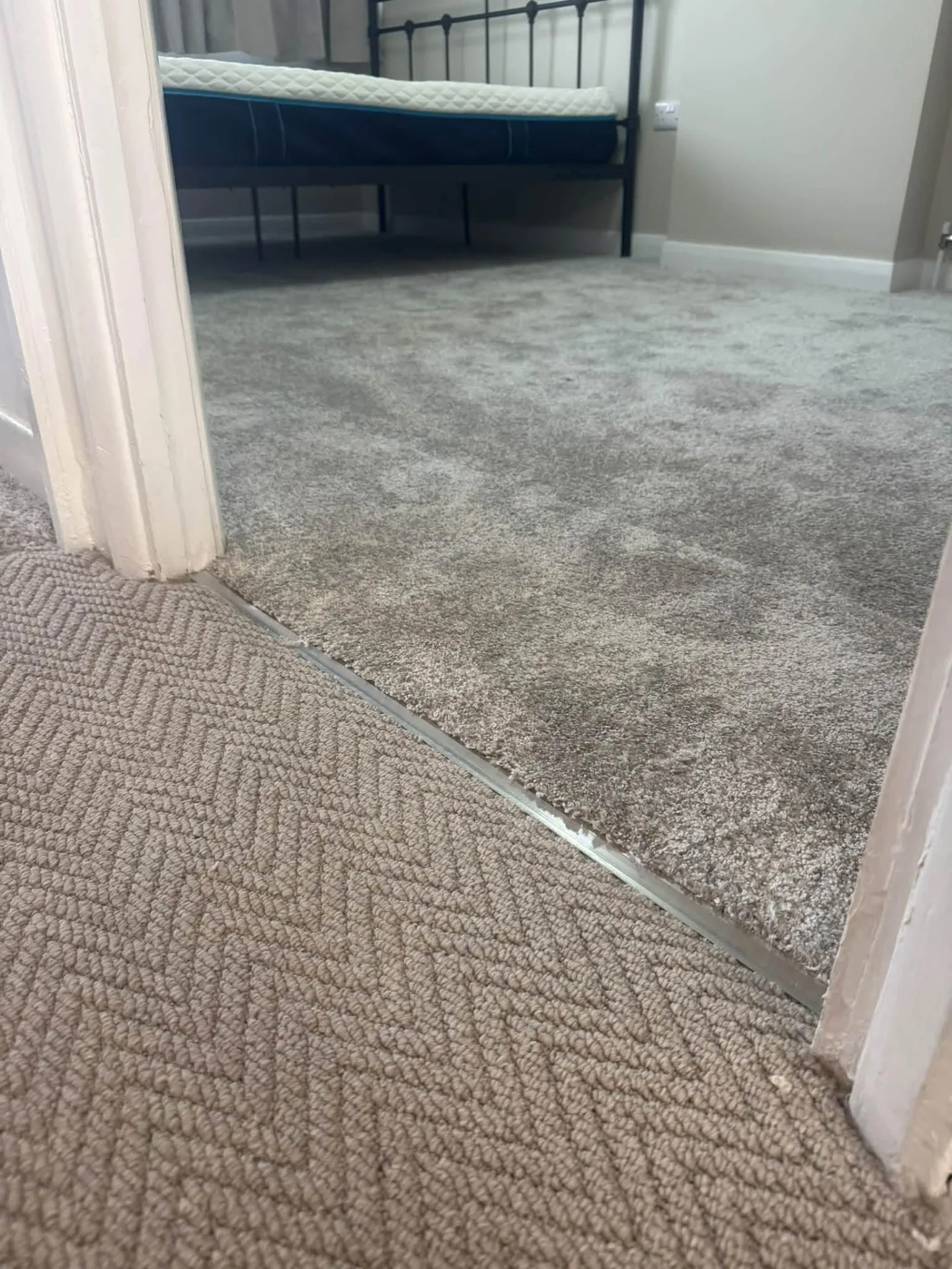 Bedroom carpet meeting a textured landing carpet at the doorway, Signature Carpets and Flooring, Greater Manchester