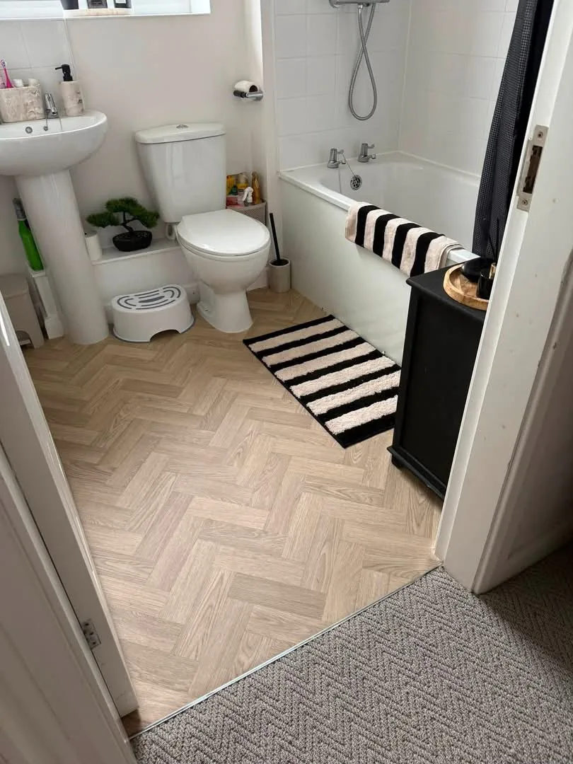 Herringbone vinyl flooring fitted in a family bathroom, Signature Carpets and Flooring, Greater Manchester
