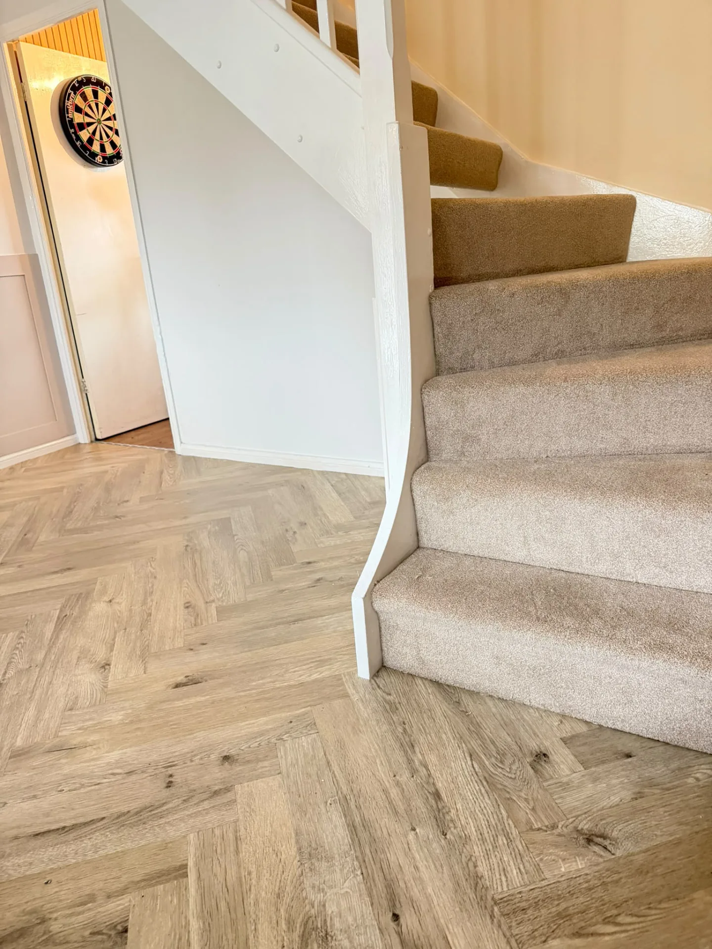 Beige stair carpet fitted beside wood-effect hallway flooring, Signature Carpets and Flooring, Greater Manchester